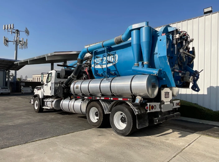 A rear view of the vacuum truck parked on the street